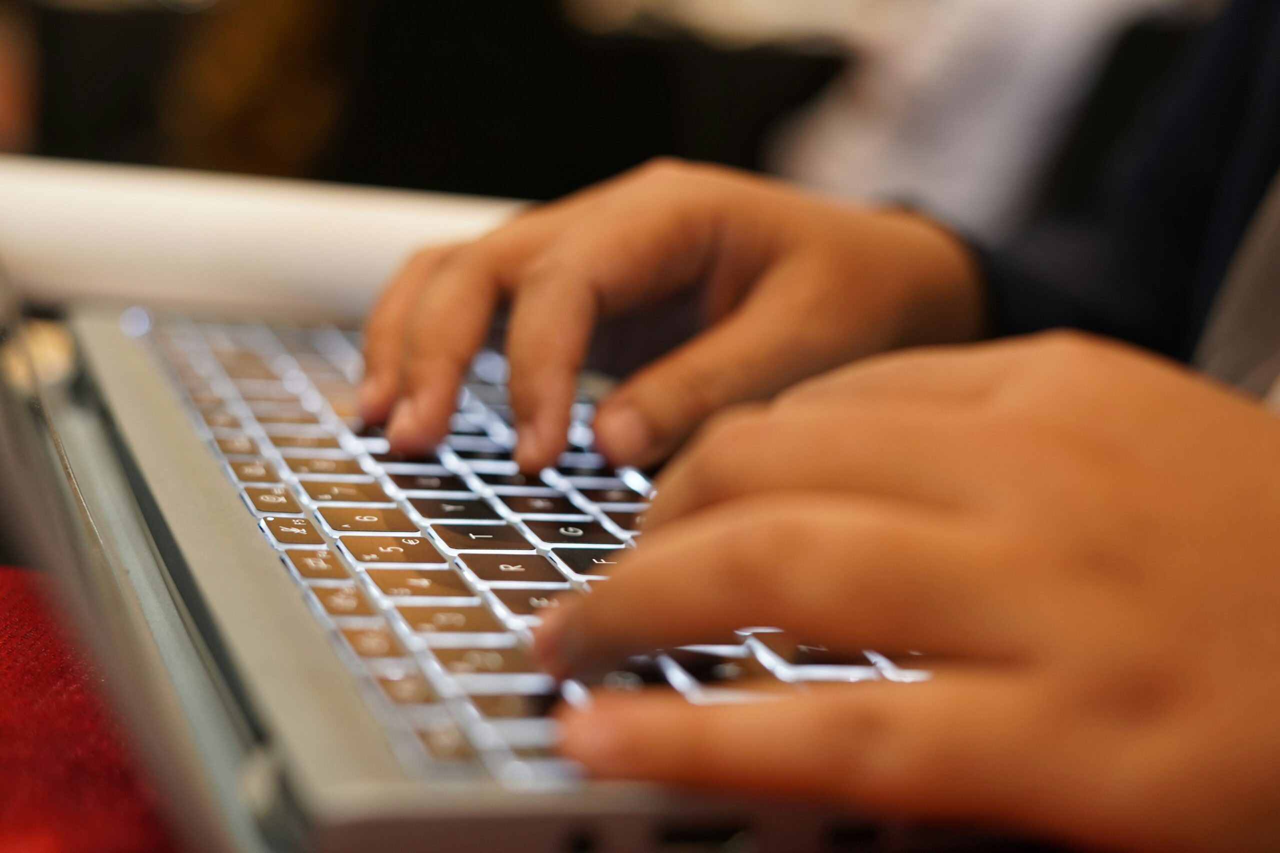 A person typing on a laptop