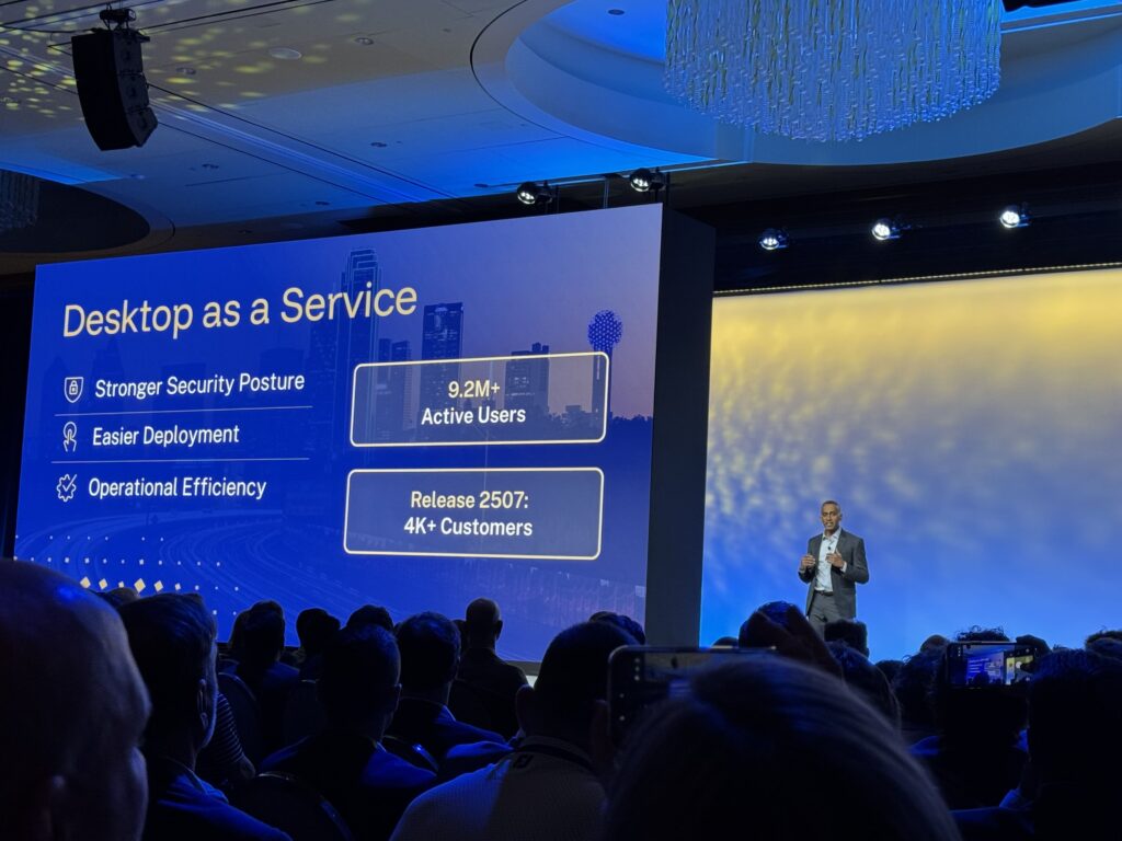 Sridhar Mullapudi, Co-President at Citrix, presenting at Citrix UNITE 2026. He stands on a stage with large projection screens behind him, and an audience in front.